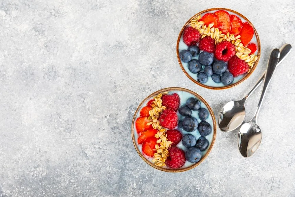 Greek yogurt is a high-protein snack, while berries are a high-fiber and nutrient-dense fruit.